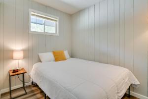 a white bedroom with a bed and a window at Kimberling City Oasis Boat Slip, Kayaks and More! in Kimberling City +18 photos