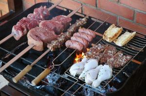 a bunch of different types of food on a grill at CAMPING RIANXO in Rianjo