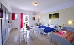 a living room with a bed and a dining room at Arlen Beach Hotel in Hersonissos +23 photos