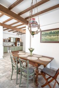 a dining room with a wooden table and chairs at Berkenyeliget Vendégház in Szigliget