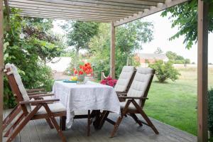 a table and two chairs on a patio at Villa Verde Österlen in Glemminge