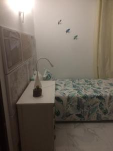 a small bedroom with a bed and a night stand at Maria Guest house in Albufeira