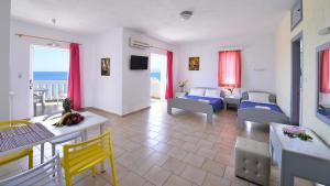 a living room with a couch and a table at Arlen Beach Hotel in Hersonissos