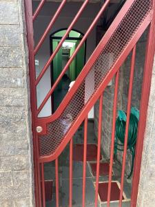 a red staircase with a red metal railing at kitnet para casal em Taguatinga-DF in Brasília