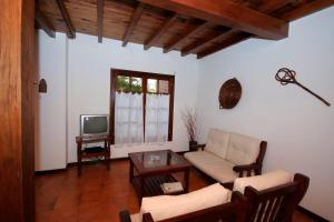 a living room with a couch and a tv at Pinamar De La Lisa in Pinamar