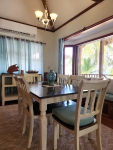 a dining room with a table and chairs at Dolphin Dreams Villa B3 in San Pedro