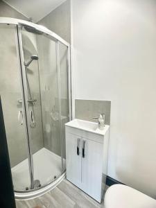 a bathroom with a shower and a sink at Gilman House in Stoke on Trent