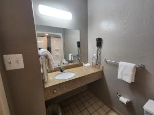a bathroom with a sink and a mirror at Motel 6-Biloxi, MS - Beach in Biloxi