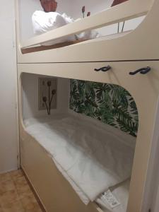 an upper bunk of a bunk bed in a room at Appartement avec piscine in Cavalaire-sur-Mer