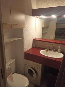 a small bathroom with a sink and a toilet at Appartement avec piscine in Cavalaire-sur-Mer