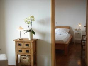 a bedroom with a bed and a table with a mirror at Villa Delina in Rab