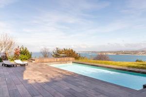 a swimming pool with a view of the water at Suite en el Faro de Hondarribia, con vistas in Hondarribia