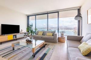 a living room with a couch and a tv at Suite en el Faro de Hondarribia, con vistas in Hondarribia