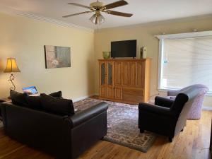 a living room with two couches and a flat screen tv at Sweet Sage House (Pets, Airport, Downtown, I-15) in Idaho Falls