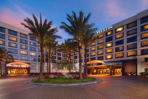 a hotel with palm trees in front of a building at The Westin San Francisco Airport in Millbrae