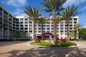 a large white building with palm trees in front of it at The Westin San Francisco Airport in Millbrae