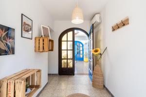 a hallway with a door and a vase of flowers at Cambrils Beach - 8 min to Beach - AC - WiFi - Terrace - 8 Guests in Cambrils +44 photos