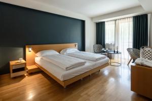 Postel nebo postele na pokoji v ubytování Grand Hotel Terme Di Comano