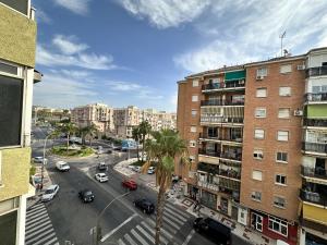 a city street with a palm tree and buildings at CG4N - Nuevo Estudio, recién reformado, Wifi in Torremolinos