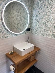 a bathroom with a white sink and a mirror at 42 Grados Norte Vadinia in Besande +25 photos