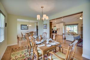 a dining room and living room with a table and chairs at Chesapeake Vacation Rental about 9 Mi to Norfolk! in Chesapeake