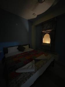 a bedroom with two beds and a window at Swiss House in Jodhpur