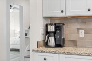a coffee maker sitting on a counter in a kitchen at Heated Pool, Arcade, 2 Kings, 75 Tv, Near Ami-img in Bradenton +59 photos