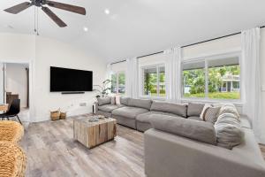 a living room with a couch and a flat screen tv at Private Heated Pool - Arcade - Pets - 2 King Beds in Bradenton