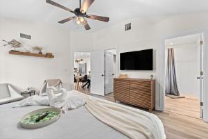a bedroom with a bed with a ceiling fan at Private Heated Pool - Arcade - Pets - 2 King Beds in Bradenton