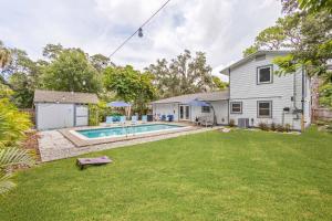 a backyard with a pool and a house at Private Heated Pool - Arcade - Pets - 2 King Beds in Bradenton