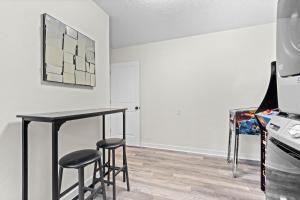 a dining room with a black table and stools at Private Heated Pool - Arcade - Pets - 2 King Beds in Bradenton