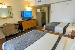 Postel nebo postele na pokoji v ubytování Quebec Motel