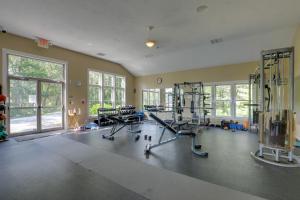a gym with treadmills and machines in a room at Inviting Summer Village Cottage Golf Cart and More! in Westford
