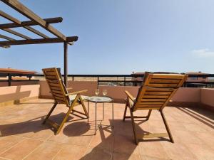 two chairs and a table on a roof at Vivienda en Lajares " Casa Sua " in La Oliva