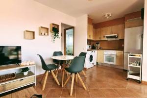 a kitchen with a table and chairs in a room at Vivienda en Lajares " Casa Sua " in La Oliva