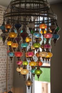 a chandelier with many different colored glass bulbs at Hotel Piano Kvareli in Kvareli