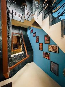 a staircase in a room with a blue wall at Swiss House in Jodhpur