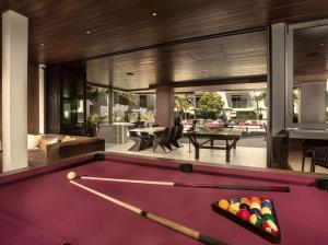a pool table in the middle of a living room at Fairfax District Chic City Oasis 2 BR Apt with Den 136 in Los Angeles