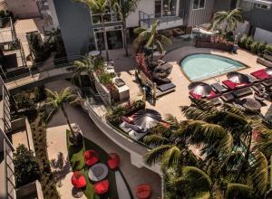an overhead view of a hotel with a pool and palm trees at Fairfax District Chic City Oasis 2 BR Apt with Den 136 in Los Angeles