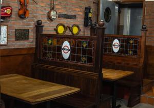 a room with two tables and mirrors on the wall at The Liverpool Pod Travel Hostel in Liverpool