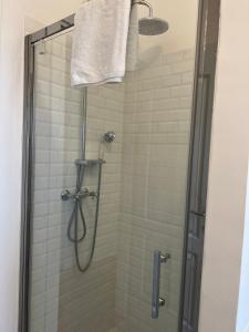 a bathroom with a shower with a towel on at Santa Rosa Florence Apartments 3 Bedrooms - Private Parking in Florence