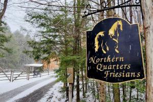 a sign with a horse on it in the snow at The Northern Quarters in Wardsboro