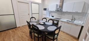a kitchen with a table and chairs in a kitchen at Old Town Tallinn Luxury Residence in Tallinn