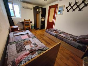 a room with two beds and a table in it at 10 Coins Hostel & tours in Sofia