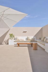 a living room with two couches and a table at Casa MareTerra - Design Villa with Pool and Terrace near Corralejo and Lajares in Corralejo