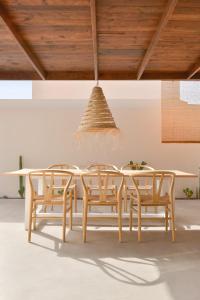 a dining room with a table and chairs at Casa MareTerra - Design Villa with Pool and Terrace near Corralejo and Lajares in Corralejo