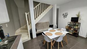 a living room with a table and a couch at Le patio St Étienne - Cité Épiscopale - Parking inclus in Albi