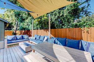 a patio with a blue couch and a wooden table at Green Cottage in Los Angeles