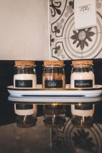 three jars of food sitting on a shelf at Studio Bougainville - Praia do Rosa in Imbituba +7 photos
