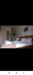 a bedroom with two beds with white pillows at D. BELONI studios in Chania